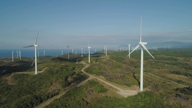 Aerial view of wind turbines for electric power production on the seashore. Bangui Windmills in Ilocos Norte, Philippines. Ecological landscape: Windmills, sea, mountains. Pagudpud