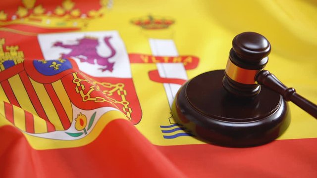 Gavel striking on sound block against Spanish flag, supreme court, legislation