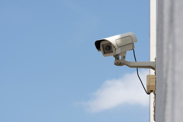 outdoor security cameras in garden , on blue sky background