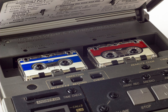 old vintage answering machine with two small tape cassettes closeup