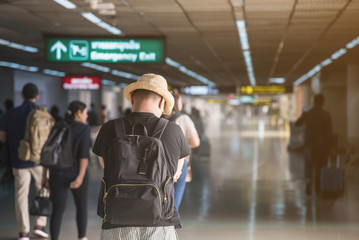 Asian Passenger walking in terminal airport building.