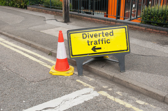 Diverted traffik road sign on asphalt.