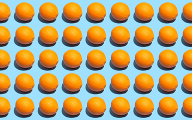 Fruit pattern of fresh orange on blue background. Top view. Summer concept. Collage. Healthy eating and dieting concept.