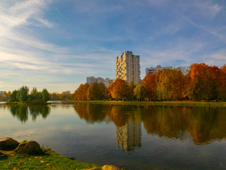 Autumn time, autumn in the city, urban autumn landscape with a pond, people walking and other fun