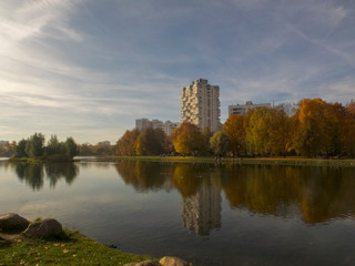 Autumn time, autumn in the city, urban autumn landscape with a pond, people walking and other fun