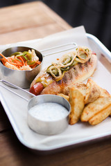 Hot dog with potatoes served on plate