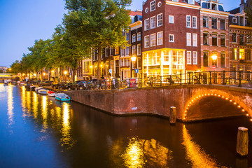 Amsterdam seen in the evening with light, canal and bridge