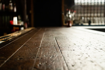 view along an old saloon style wooden bar with negative space for design elements