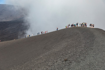Trekking di escursionisti e turisti in trekking durante un escursione sul cratere del Vulcano Etna in Sicilia © Etna ·REC Attivo
