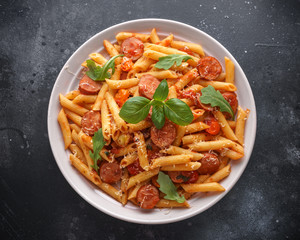 Sausage penne Pasta with tomato sauce and fresh herbs