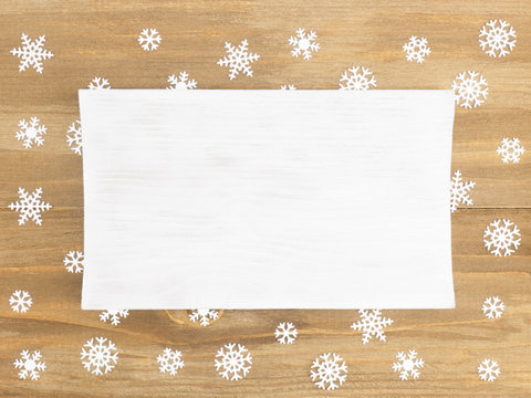 Brown wooden Christmas background with snowflakes. Christmas and New Year concept