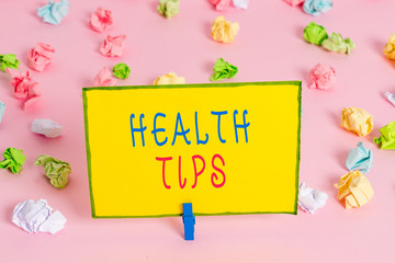 Word writing text Health Tips. Business photo showcasing advice or information given to be helpful in being healthy Colored crumpled papers empty reminder pink floor background clothespin
