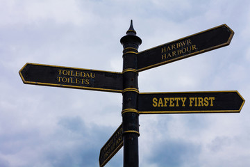 Word writing text Safety First. Business photo showcasing used to say that the most important thing is to be safe Road sign on the crossroads with blue cloudy sky in the background