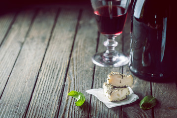 Soft goat cheese with herbs on the old dark wooden table