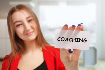 Business, technology, internet and networking concept. Young entrepreneur showing keyword: Coaching