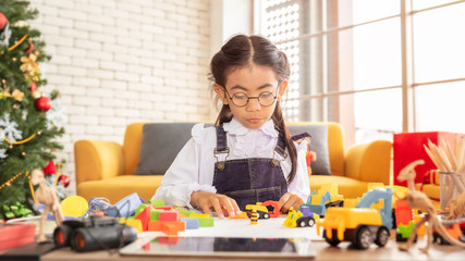 Happy holidays and Merry Christmas.Kid girl playing toys at home.