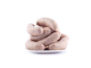 fresh raw sausages on a plate for cooking on charcoal isolated