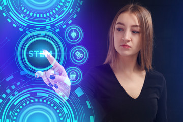 The concept of business, technology, the Internet and the network. A young entrepreneur working on a virtual screen of the future and sees the inscription: STEM