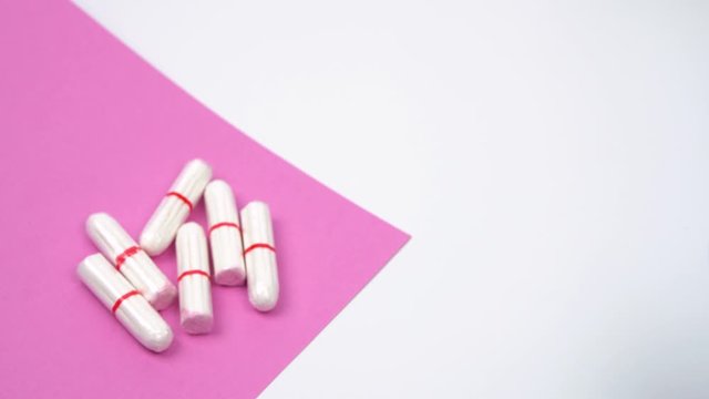 the female hand chooses the menstrual cup as an alternative to hygienic tampons, personal care products during menstruation period time