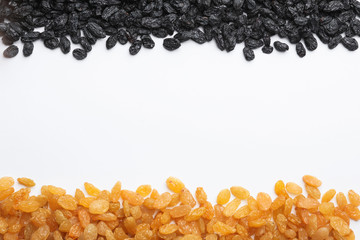 Many raisins and space for text on white background, top view. Dried fruit as healthy snack