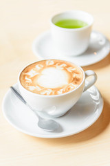 hot cappuccino coffee with green tea on table