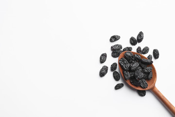 Spoon with raisins and space for text on white background, top view. Dried fruit as healthy snack