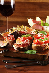 Tasty savory tomato Italian appetizers, or bruschetta on slices of toasted baguette garnished with basil