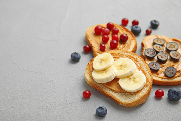 Slices of bread with different toppings on grey table