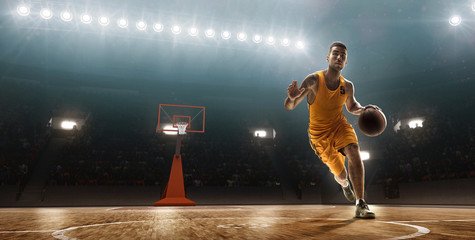 Basketball player runs with the ball on basketball court