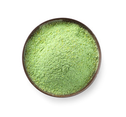 Bowl with wheat grass powder on white background, top view