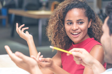 Young businessman and businesswoman in casual clothes having a new project discussion or having an idea at workplace.