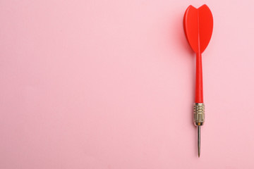 Red dart arrow on pink background, top view with space for text