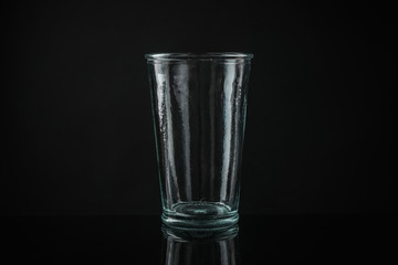 Elegant empty colorful glass on black background