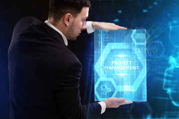 The concept of business, technology, the Internet and the network. A young entrepreneur working on a virtual screen of the future and sees the inscription: Project management