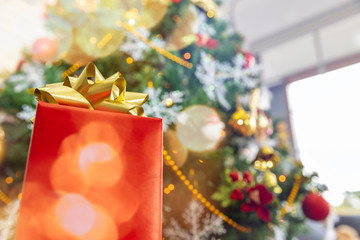 Christmas gift box on tree background with copy space.