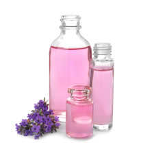 Obraz na płótnie Canvas Bottles of essential oil and lavender flowers isolated on white