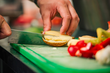 Cutting cooked potato and vegetables, close-up.
