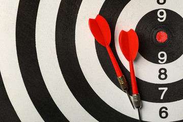 Red arrows on dart board, top view