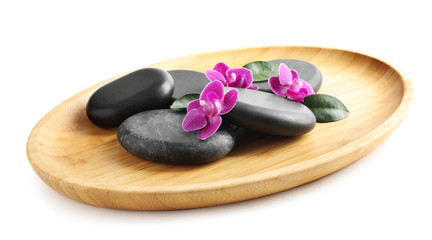 Fototapeta na wymiar Wooden tray with spa stones and orchid flowers on white background