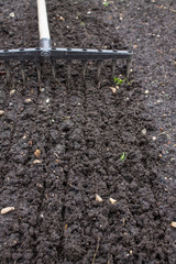 Loosening the excavated ground with a rake close-up