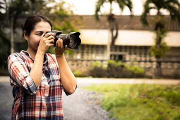 Fototapeta na wymiar Woman photographer is taking images with dslr camera.Asian woman photographer