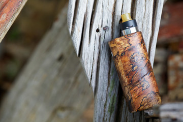 high end natural stabilized wood regulated box mods with rebuildable dripping atomizer and ultem drip tip, vaping device, selective focus