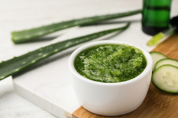 Wooden board with handmade face mask made and ingredients on white table