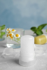 Natural crystal alum deodorant on light grey marble background