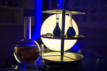 Silhouettes of flasks and tubes in the laboratory.
