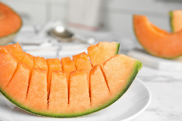 Slices of ripe cantaloupe melon on marble table, closeup
