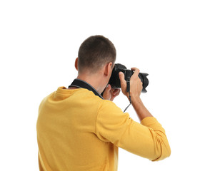Young photographer with professional camera on white background, back view