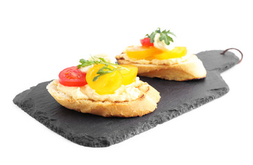 Slate board with delicious tomato bruschettas on white background