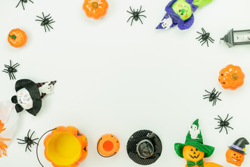 Table top view aerial image of decoration Happy Halloween day background concept.Flat lay accessories essential object to party the pumpkin & doll and candy on white wooden.Space for creative design.