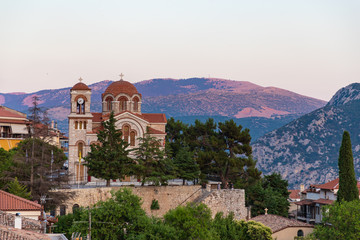Fototapeta na wymiar Church in Delphi town during sunset. Greece